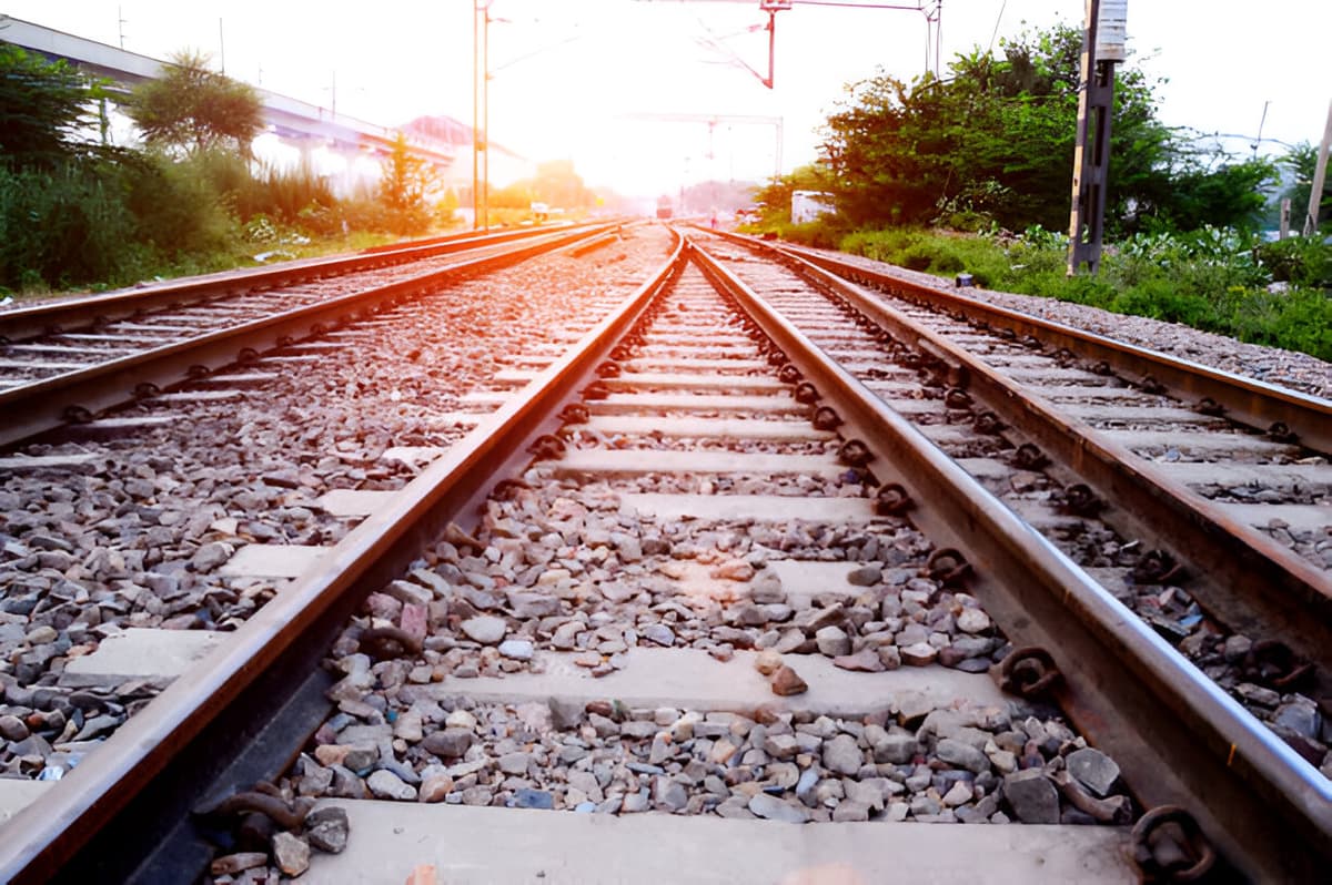 Modern train inside a large industrial train manufacturing plant with equipment and machinery